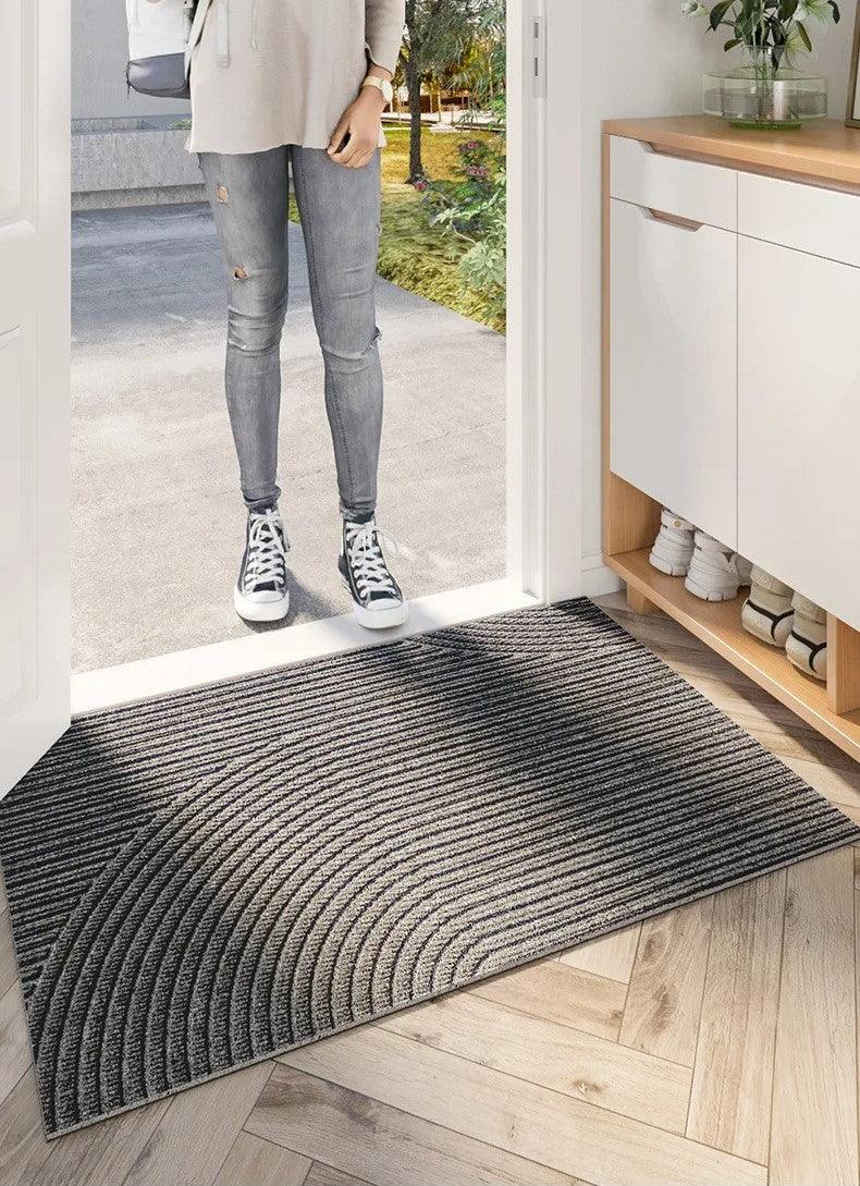 Rectangular ribbed geometric door mat in an indoor entryway