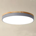 Round flush LED ceiling light with wood-effect trim and circular diffuser