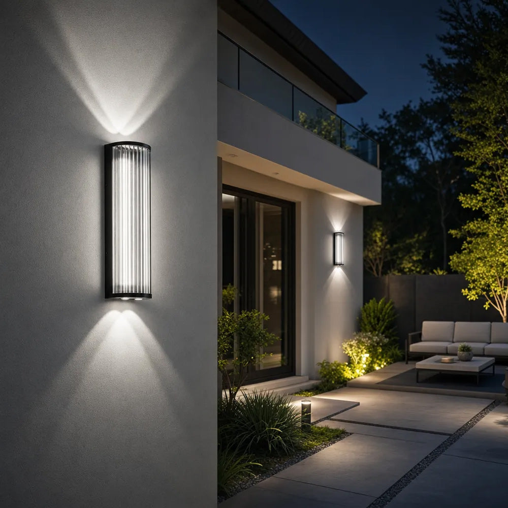 Black outdoor wall light with vertical glass shade and up and down illumination