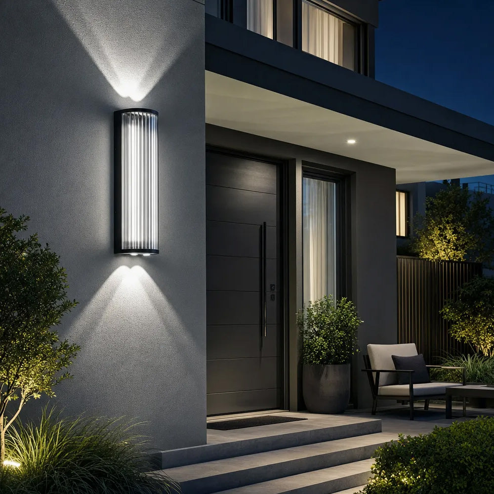 Black outdoor wall light with vertical glass shade and up and down illumination