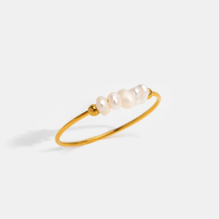Gold-tone ring with a row of white pearl details