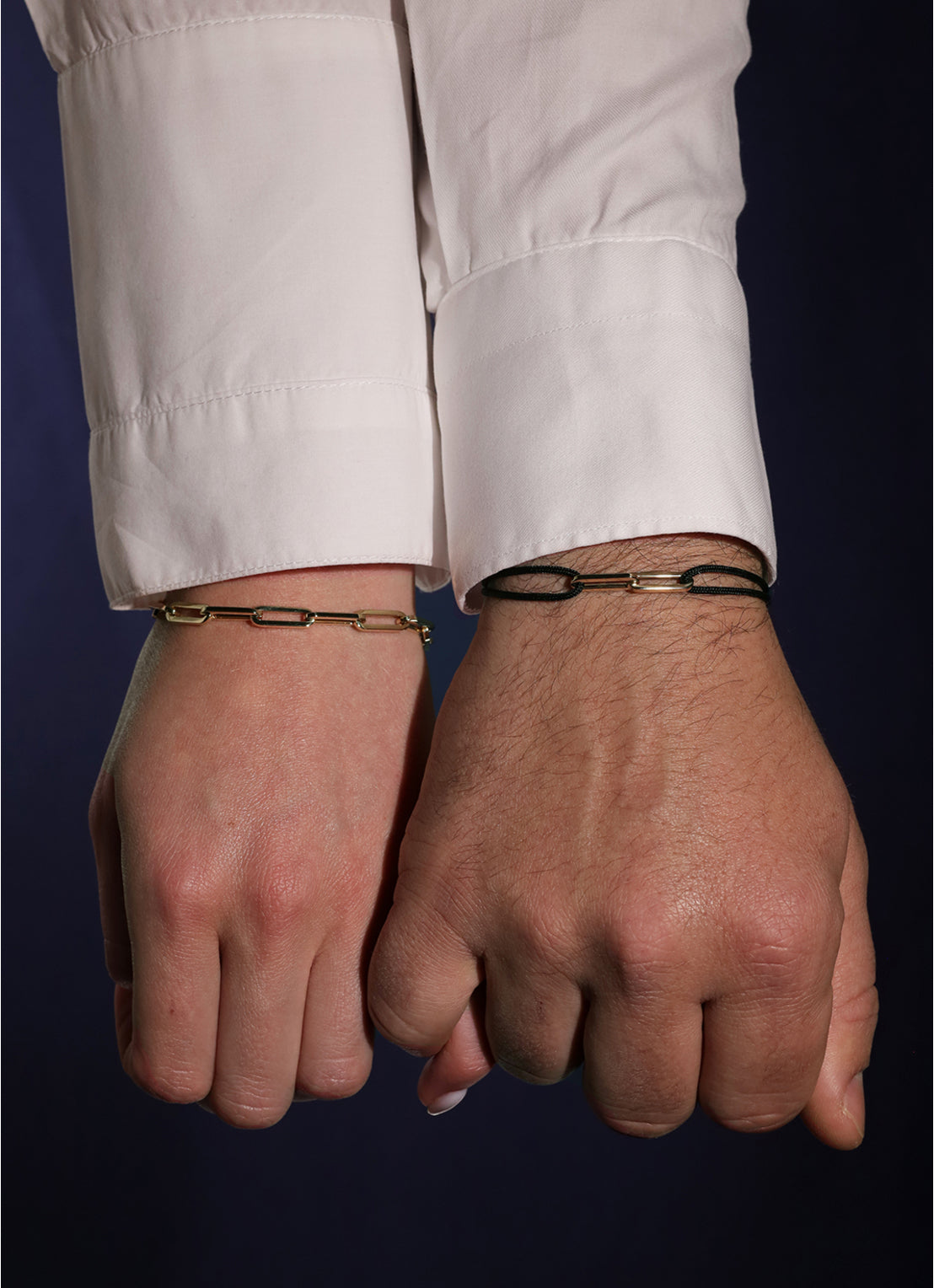 Black cord bracelet with yellow-gold-tone link closure and round charm