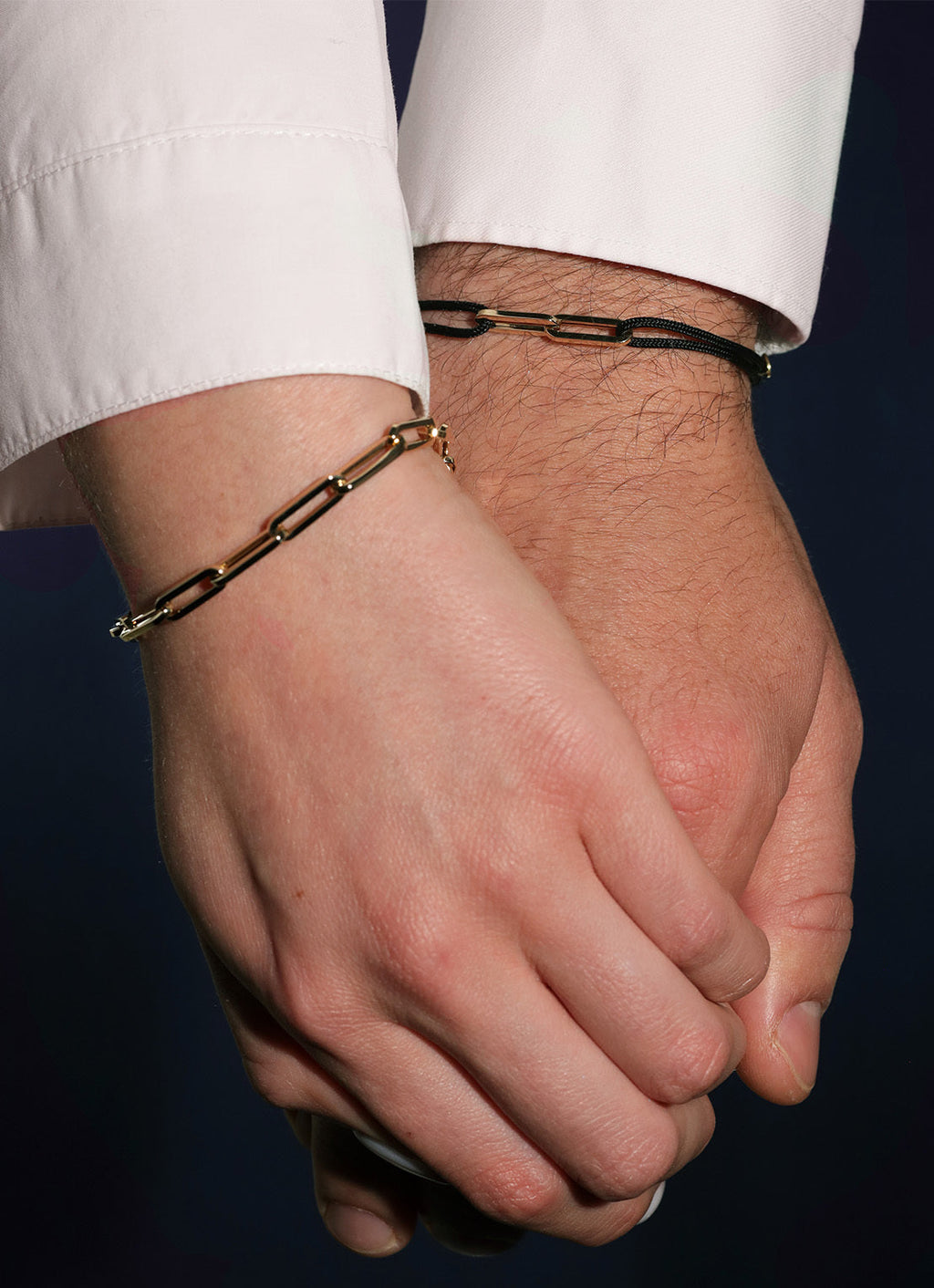 Black cord bracelet with yellow-gold-tone link closure and round charm