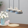 Three-shade LED pendant light with wood-effect bar and decorative bird figures