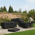 Weather-resistant cover fitted over outdoor patio furniture