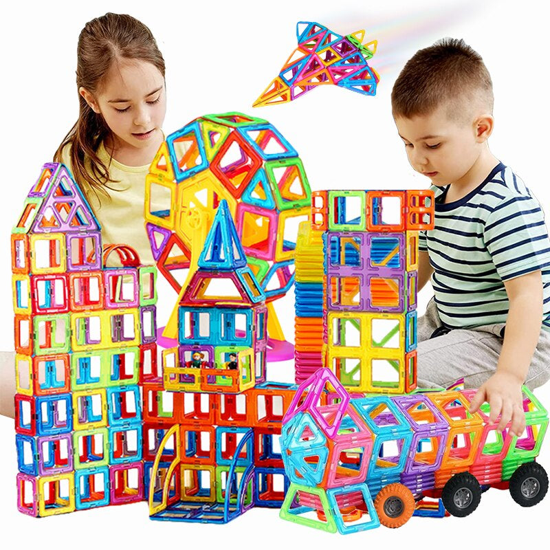 Colourful magnetic building tiles arranged into houses, towers and vehicles