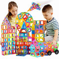 Colourful magnetic building tiles arranged into houses, towers and vehicles
