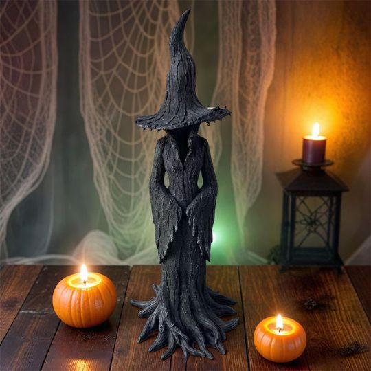 Black Halloween witch figurine with pointed hat and flowing sculpted robe