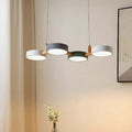 Four-shade suspended pendant light with circular shades and connecting bar