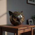 Seated stone cat figurine with pointed ears and large inset eyes
