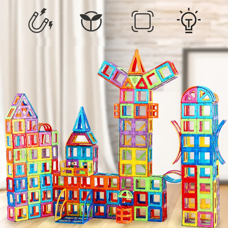 Colourful magnetic building tiles arranged into houses, towers and vehicles