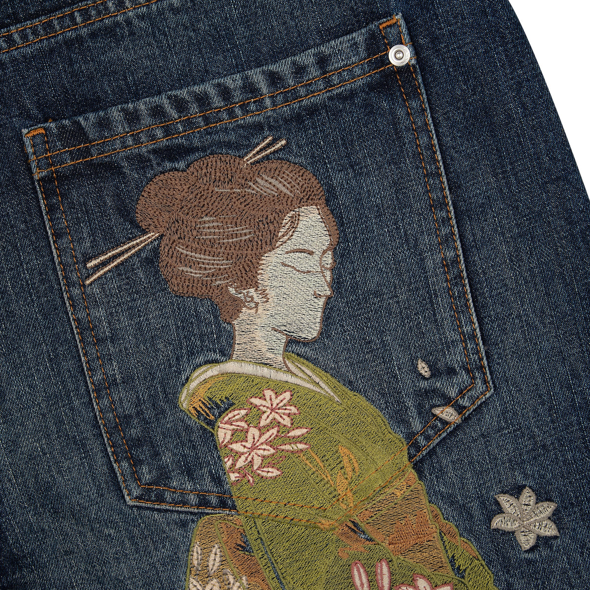 Indigo blue straight leg jeans with floral and Japanese-inspired back embroidery