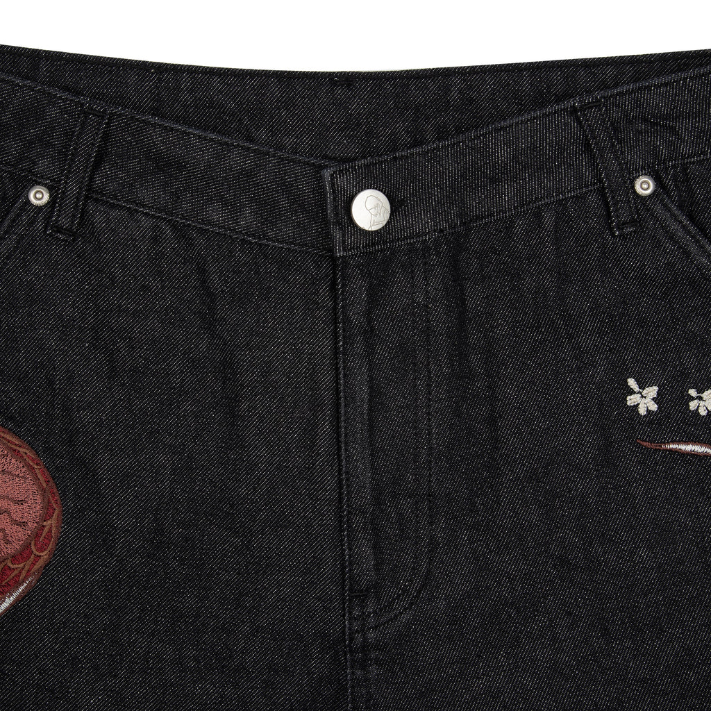 Black raw denim jeans with red and white dragon graphics