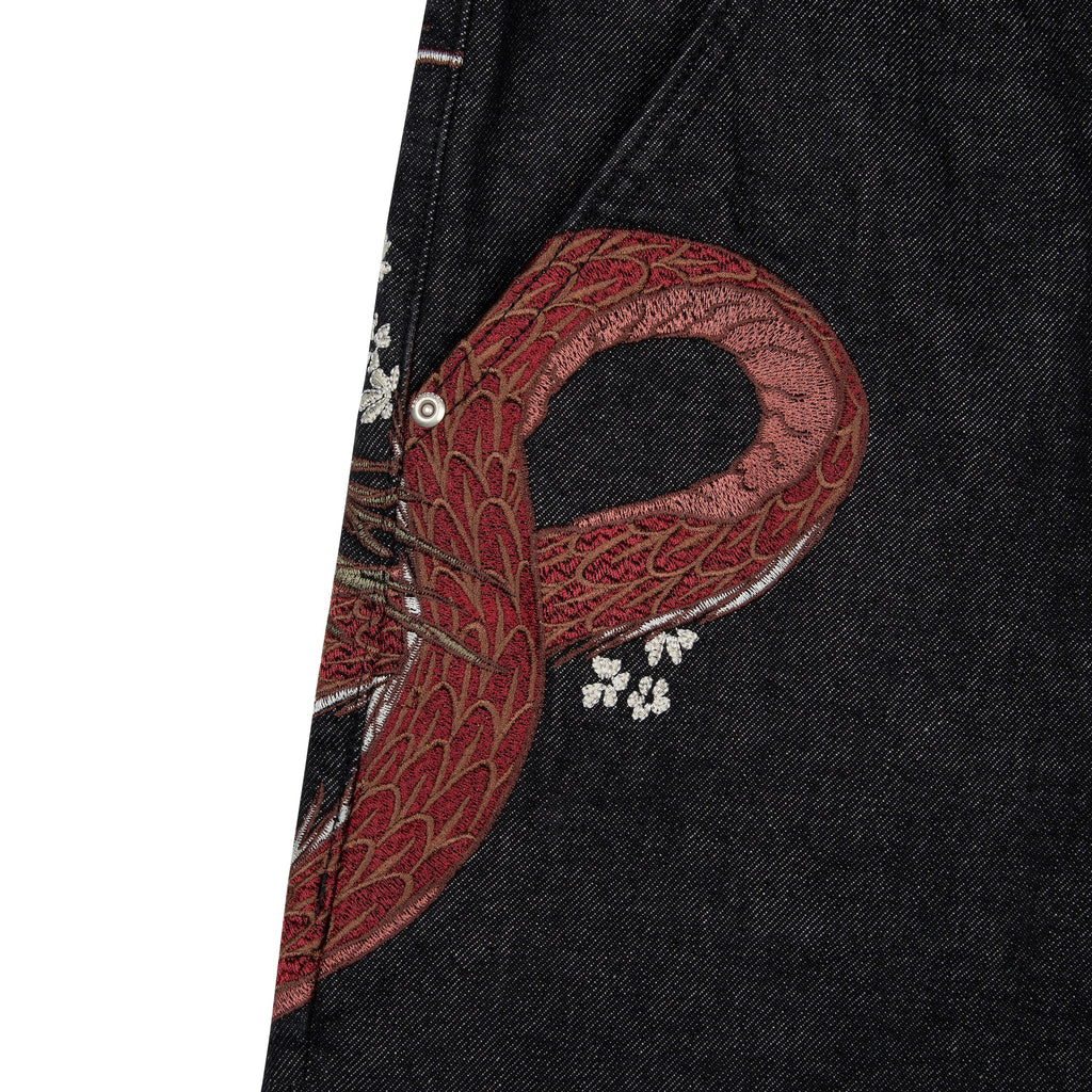 Black raw denim jeans with red and white dragon graphics
