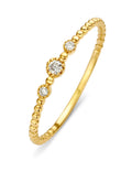 Yellow gold ring with beaded band and three diamond-set accents