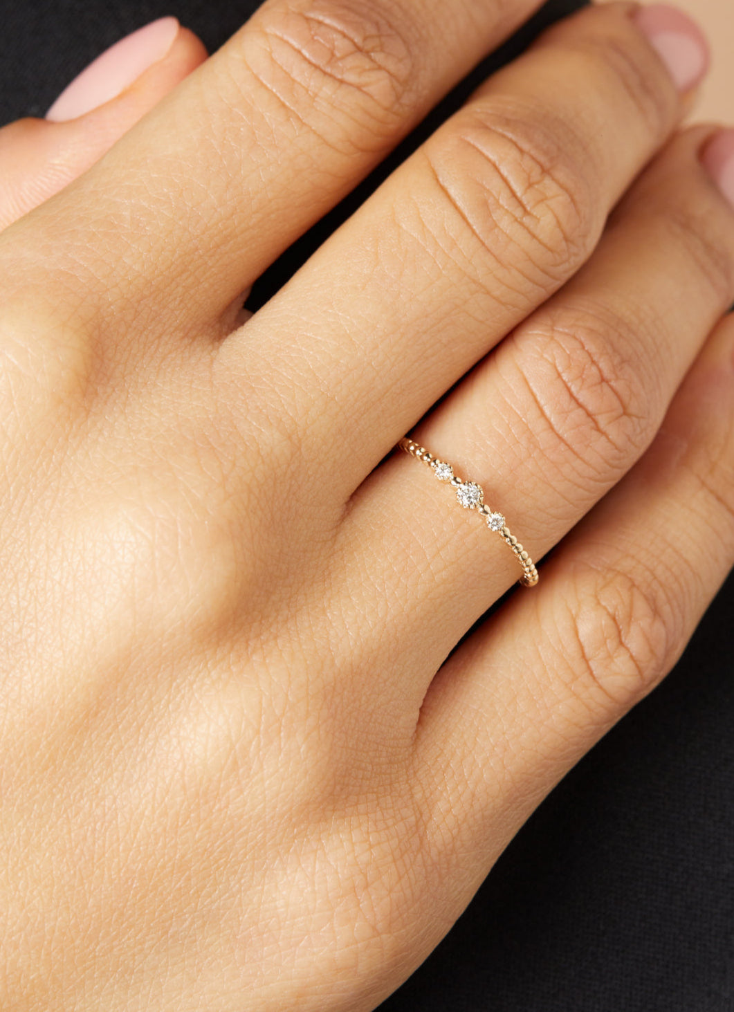 Yellow gold ring with beaded band and three diamond-set accents