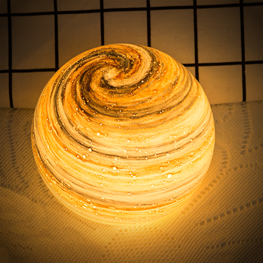 Spherical glass moon table lamp with swirling cosmic detailing