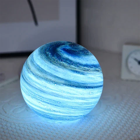 Spherical glass moon table lamp with swirling cosmic detailing
