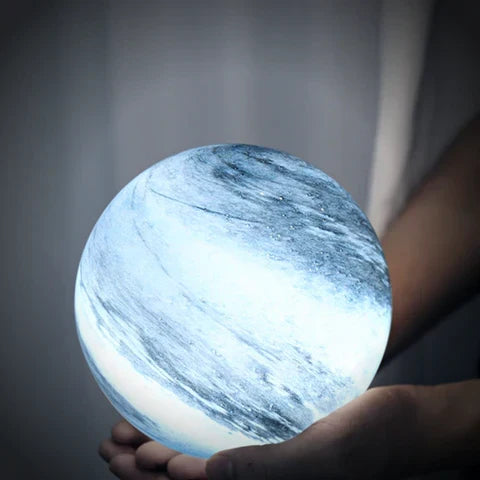 Spherical glass moon table lamp with swirling cosmic detailing
