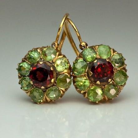 Gold-tone drop earrings with green clusters and red centre stones