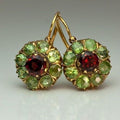 Gold-tone drop earrings with green clusters and red centre stones