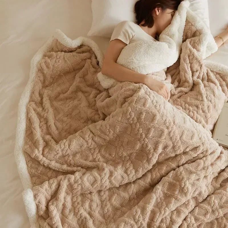 Plush textured fleece blanket with contrasting light edge on a bed