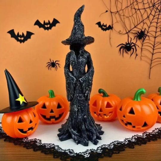 Black Halloween witch figurine with pointed hat and flowing sculpted robe