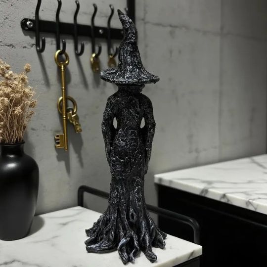Black Halloween witch figurine with pointed hat and flowing sculpted robe