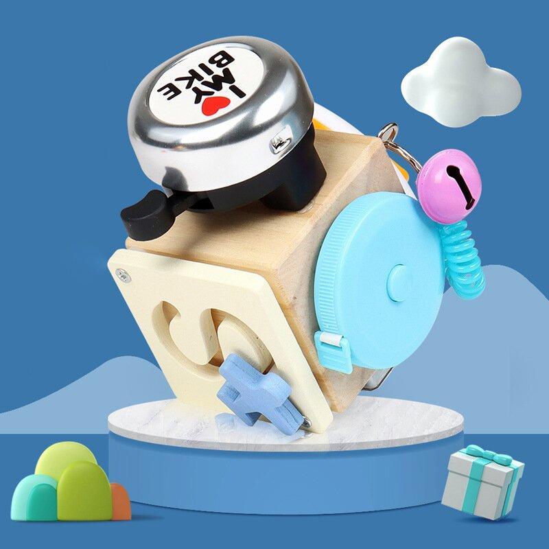 Busy cube activity toy with wood-effect panels, spinner, bell and moving parts