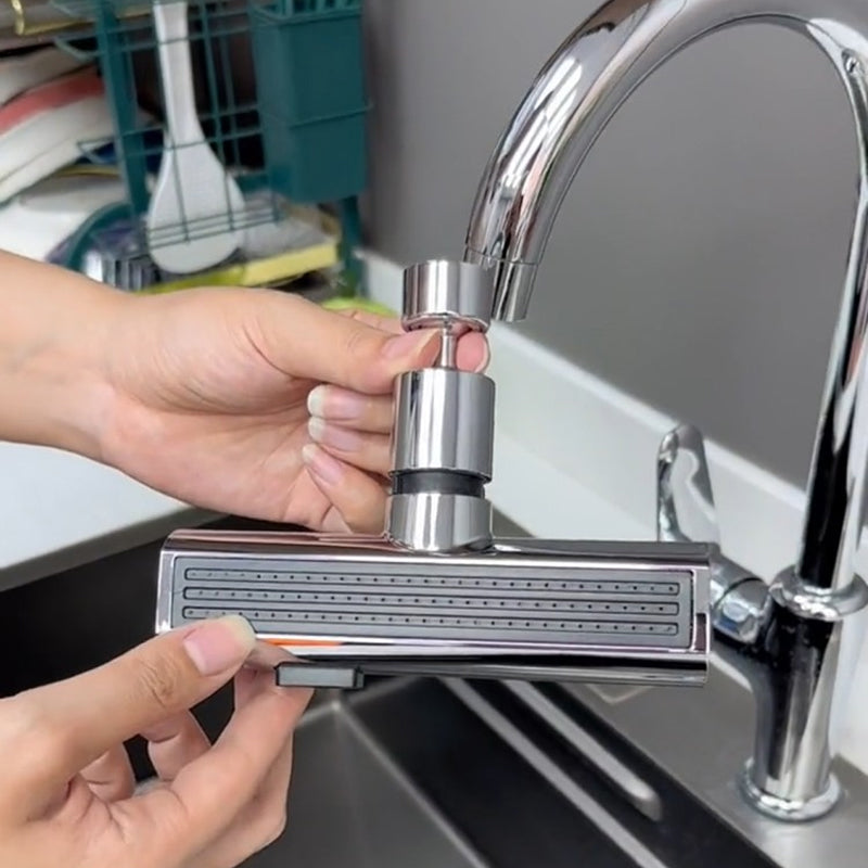 Chrome kitchen faucet attachment with flexible spray head over a sink