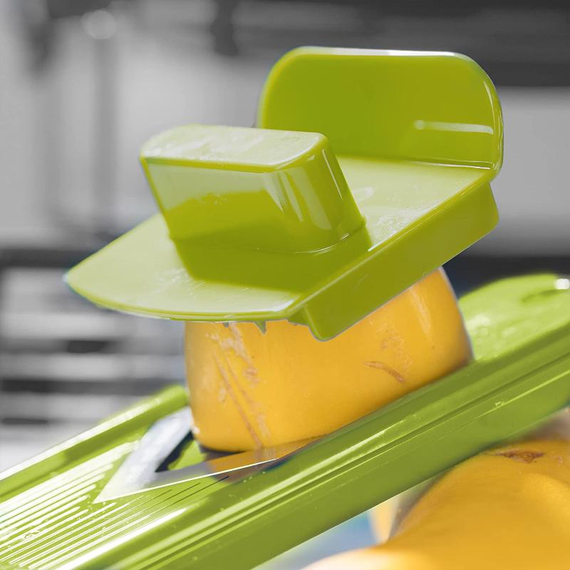 Green 12-in-1 vegetable slicer with cutting inserts and clear collection container
