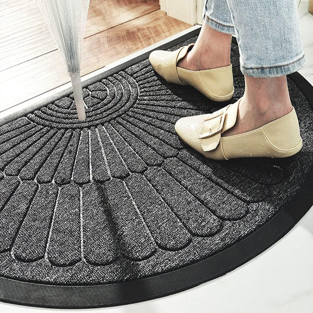 Semi-circular textured rubber door mat with raised fan pattern