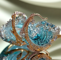 Wave design dangle earrings with blue and clear decorative detailing