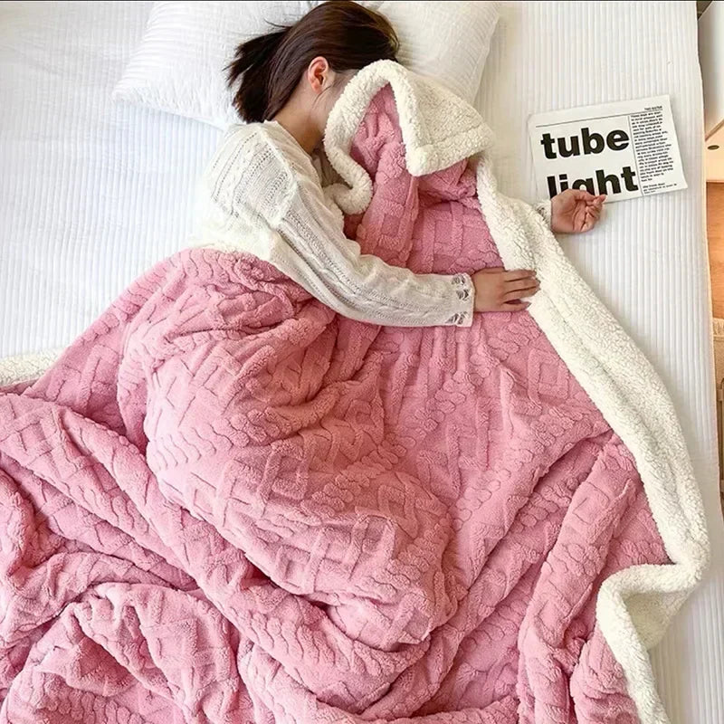 Plush textured fleece blanket with contrasting light edge on a bed