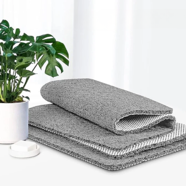 Textured non-slip shower mat beside a bathtub