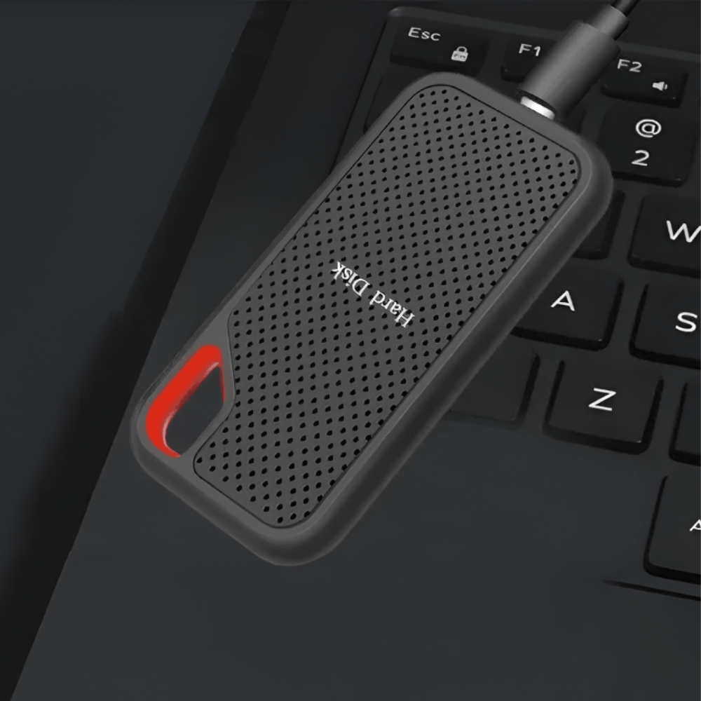 Black portable external SSD hard drive with red carry handle and USB cable