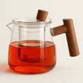 Glass teapot with central infuser, fitted lid and wooden handle