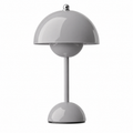 Wireless table lamp with a rounded dome shade and slim central stem