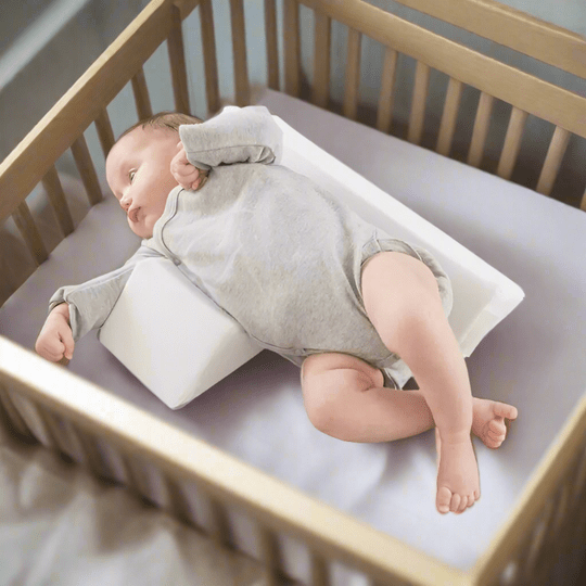 Infant sleep positioning pillow with central padded area and raised side supports