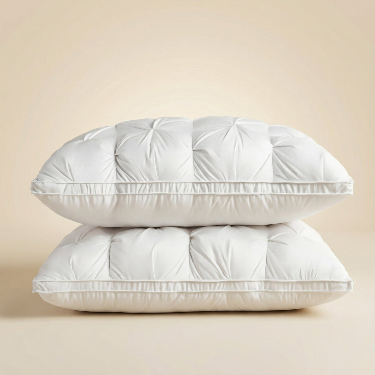 Tufted rectangular bed pillows with piped edges stacked on a bed