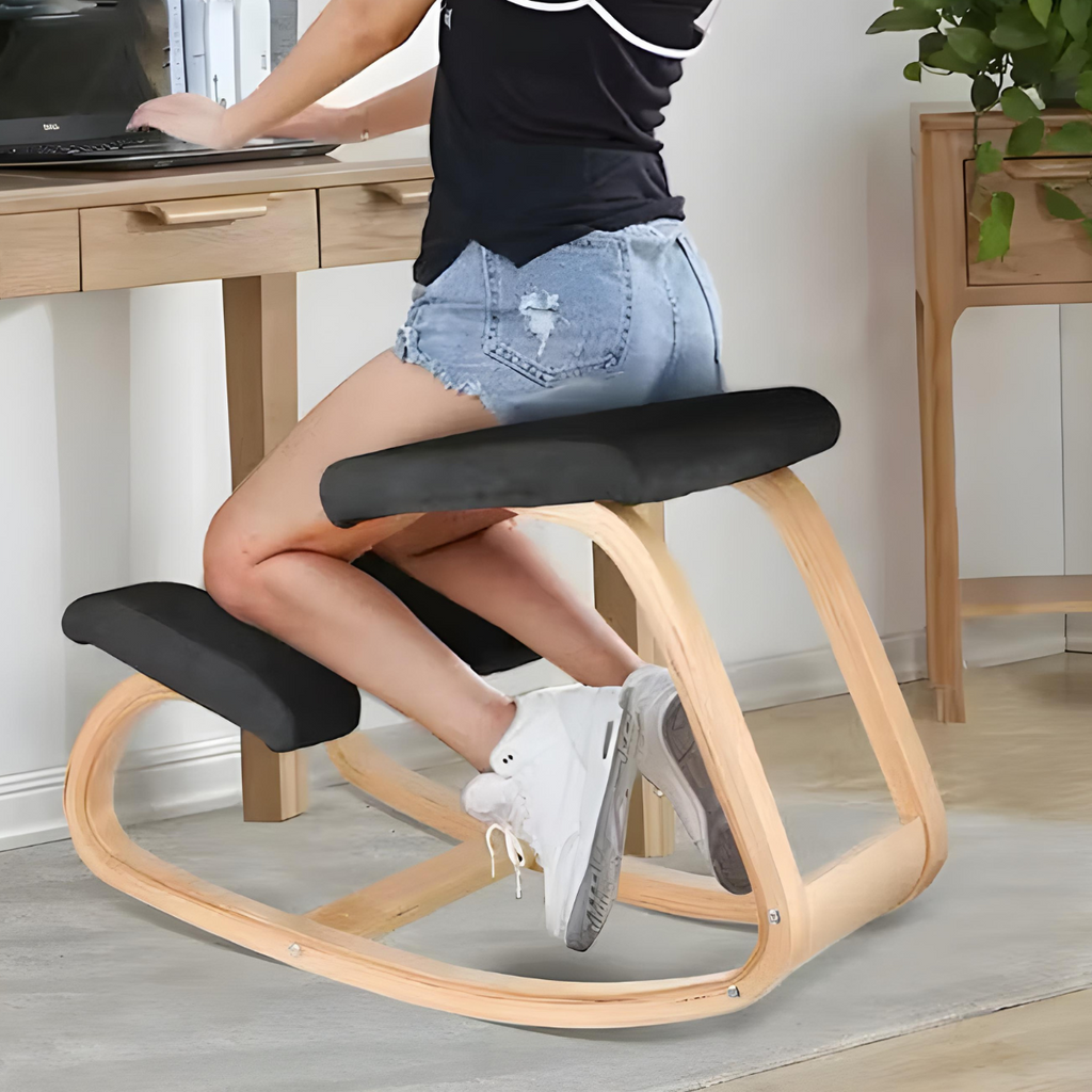 Ergonomic kneeling chair with black cushions and curved light wood-tone frame