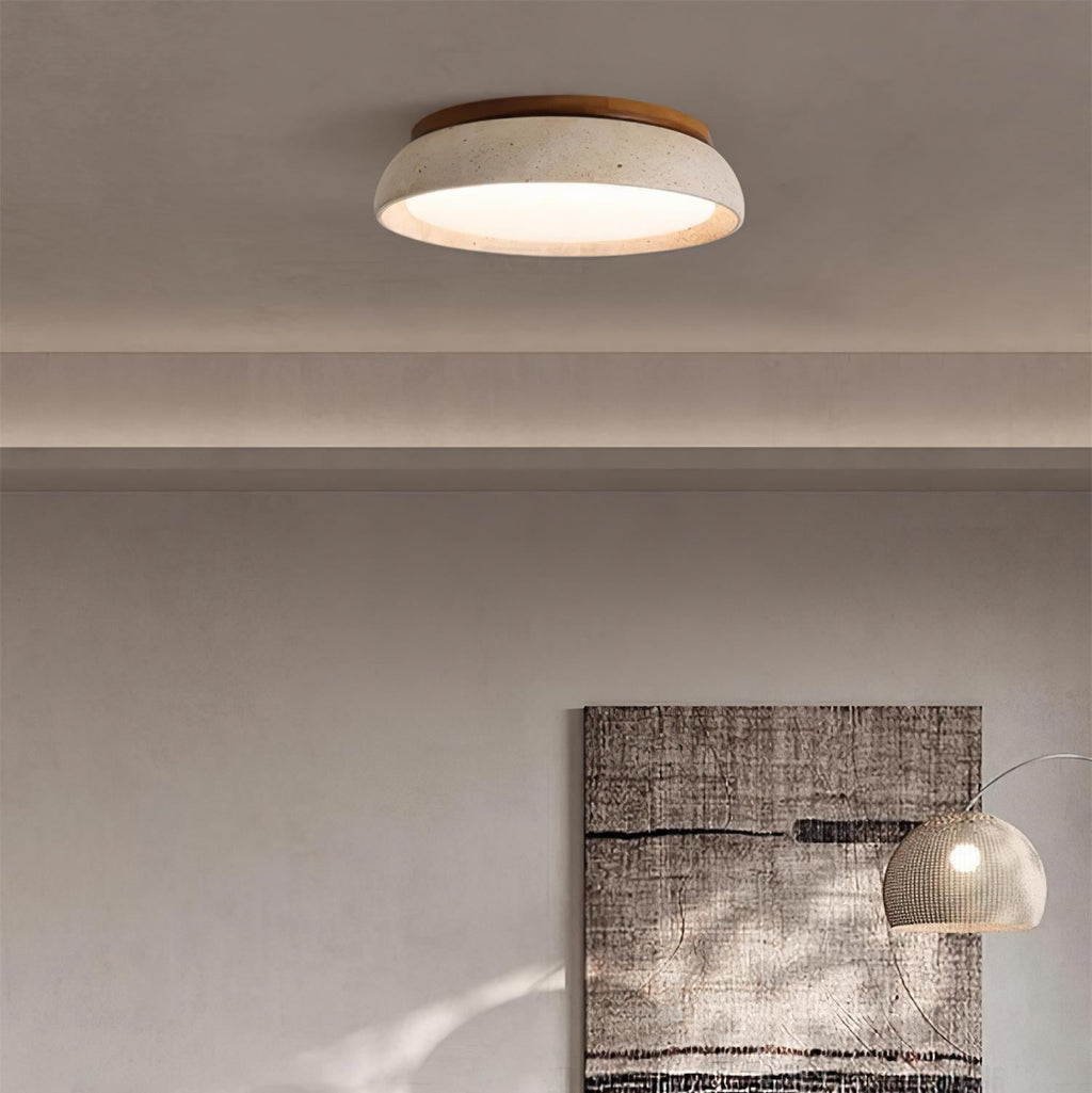 Round flush mount ceiling light with travertine finish and wood-effect trim