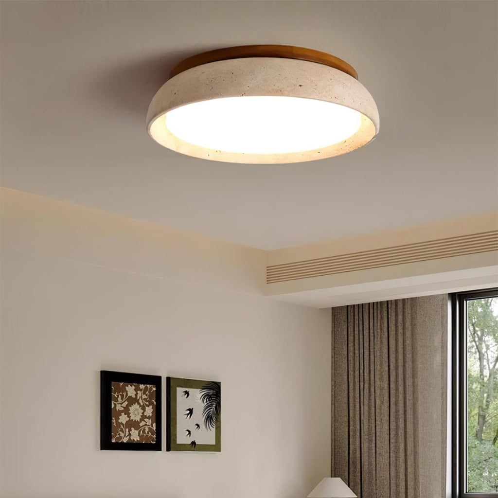 Round flush mount ceiling light with travertine finish and wood-effect trim