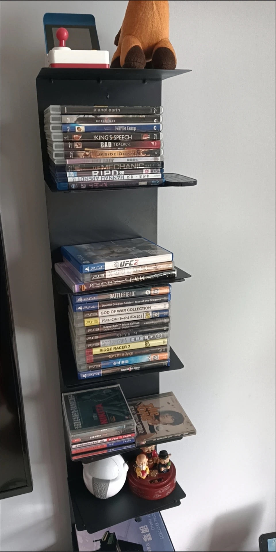 Vertical metal bookshelf with open shelves and a rectangular base