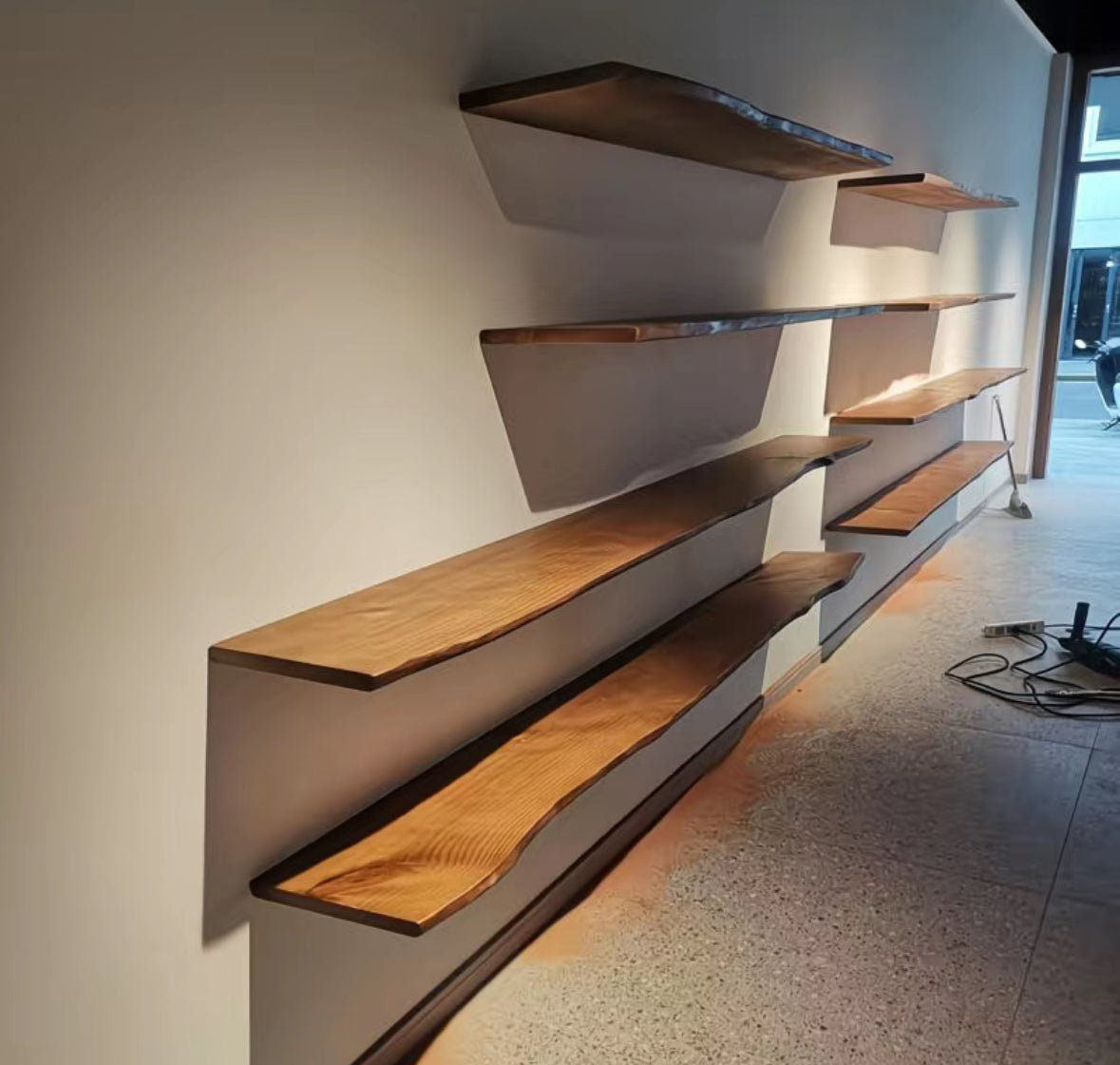 Brown hardwood wall shelf with a naturally shaped live edge