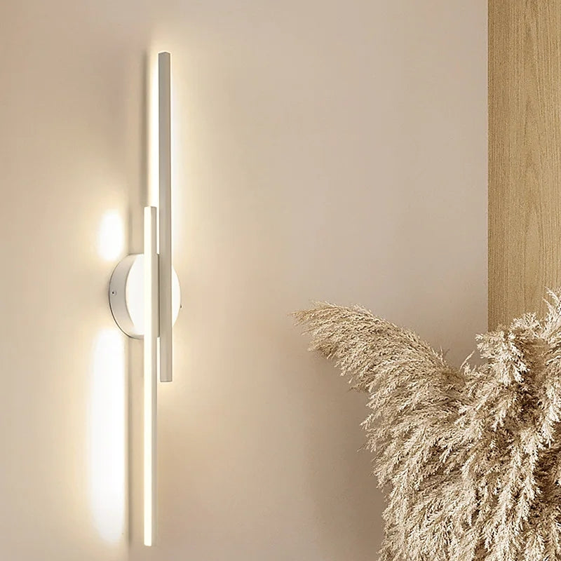 Minimalist metal wall sconce with round backplate and vertical bars