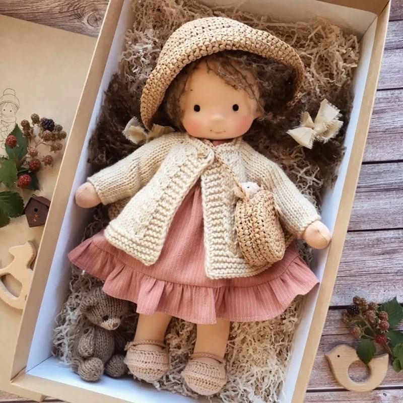 Handmade dressed Waldorf-style cloth doll with knitted animal companion in a presentation box