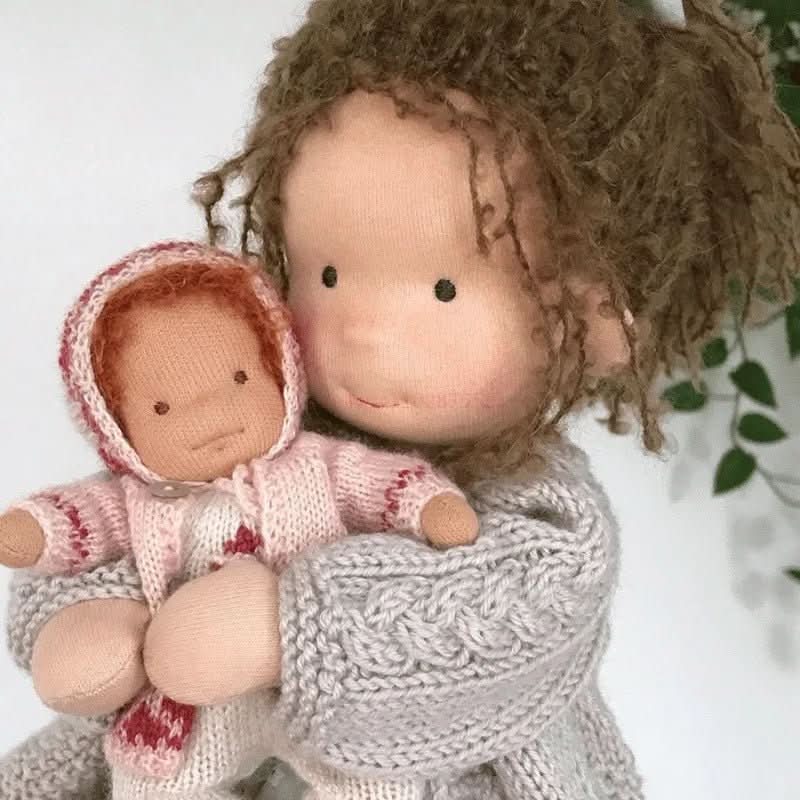 Handmade dressed Waldorf-style cloth doll with knitted animal companion in a presentation box
