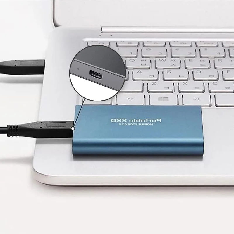 Portable SSD external drive connected to a laptop with USB cable