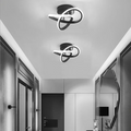 Set of two modern looping LED ceiling lights installed along a hallway